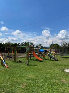 a park with a playground with slides and swings at Mahawi Resort in Calarcá
