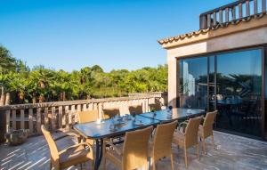 a dining table and chairs on a patio at Finca Sa Pedrera in Can Picafort
