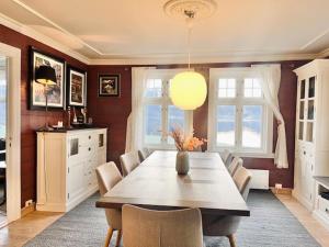 a dining room with a wooden table and chairs at Oanes House in Forsand