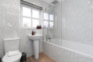 a bathroom with a toilet and a sink and a shower at Buie's Runway Retreat in EDI