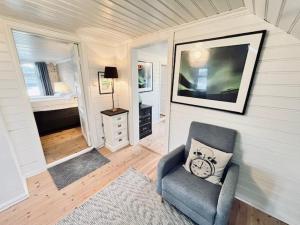 a living room with a chair and a bedroom at Oanes House in Forsand