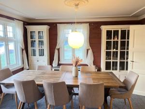 a dining room with a wooden table and chairs at Oanes House in Forsand +13 photos