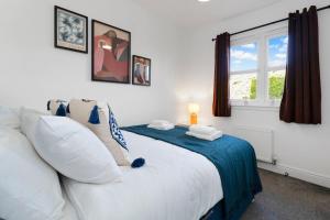 a bedroom with a large white bed with a window at Buie's Runway Retreat in EDI