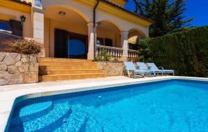 a swimming pool in front of a house at Ca Nostra in Cala Millor