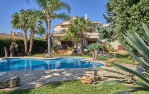 a house with a swimming pool and palm trees at Can Gual in Inca