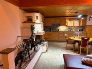 a kitchen with a dog on the wall in a room at Panorama-Chalet Unterbach in Hinwil +24 photos