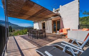 a patio with a table and chairs on a deck at Arbona Soller in Sóller