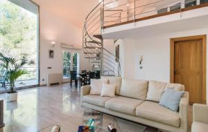 a living room with a couch and a spiral staircase at Cocodrilo in Alcudia