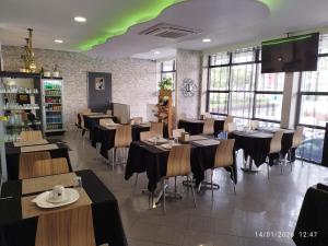 a restaurant with tables and chairs and a green ceiling at Alojamento Central I - Funchal in Funchal
