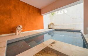 a house with a swimming pool with a cat standing next to it at Ca Sa Batlessa in Artá