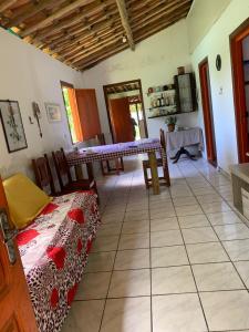 a living room with a table and chairs in a room at Fazenda Shalom in Tucano