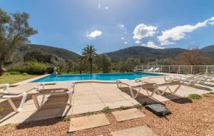 a swimming pool with a bunch of chairs next to it at Sa Tafona in Esporles