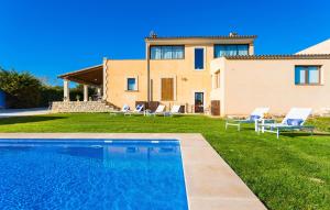 a villa with a swimming pool in front of a house at Finca Llum in Manacor