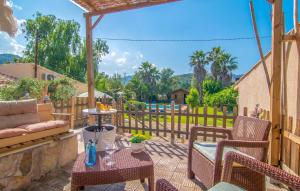 a patio with a couch and chairs and a table at Can Bleio in Pollença