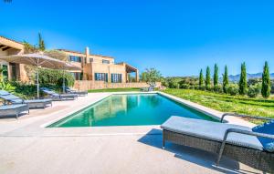 a swimming pool in front of a house at Esteva in Sant Llorenç des Cardassar