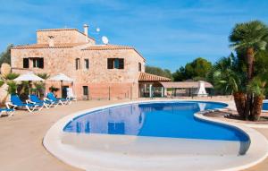 a swimming pool in front of a villa at Can Picafort in Can Picafort
