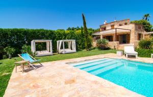 a villa with a swimming pool and a house at Son Artigues in Manacor