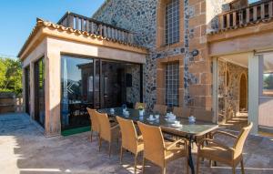 a patio with a table and chairs and a building at Finca Sa Pedrera in Can Picafort
