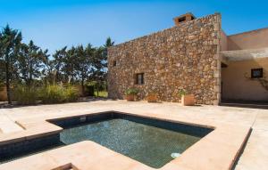 a swimming pool in front of a stone building at Es Triquet in Binissalem +44 photos