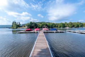 a dock on a lake with boats on it at American Eagle Lodge by Railey Vacations in McHenry