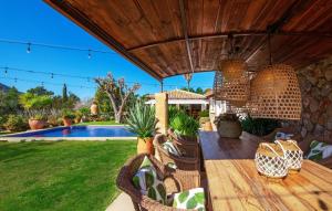 an outdoor patio with wicker chairs and a wooden deck at Can Sion in Esporlas