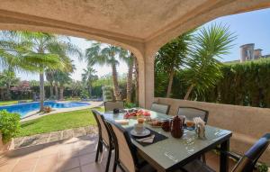 a table and chairs on a patio with a pool at Can Gual in Inca +44 photos