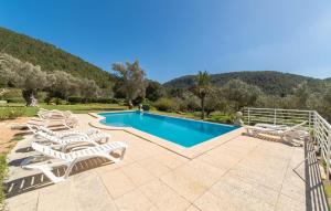 a villa with a swimming pool and lounge chairs at Sa Tafona in Esporles