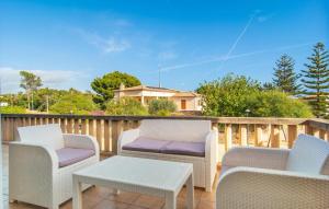 three chairs and a table on a deck at Es Ganxo House in Porto Cristo