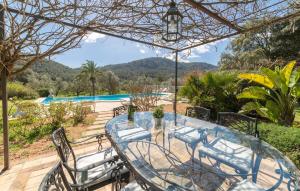a patio with a table and chairs and a pool at Sa Tafona in Esporles +54 photos