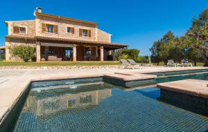 a house with a swimming pool in front of a house at Es Triquet in Binissalem