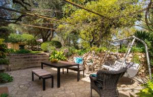 a patio with a table and chairs and a swing at Can Pintad in Ruberts +34 photos