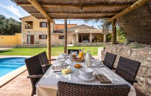 a table with food on it next to a pool at Ca Na Conceda in Alcudia