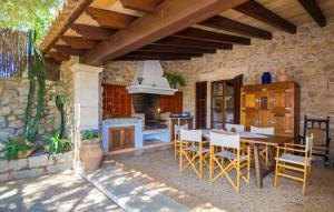 a kitchen and dining room with a table and chairs at Sos Monjos in Artá