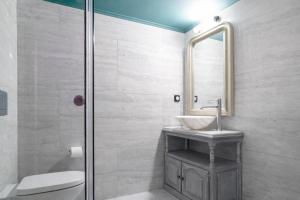 a bathroom with a sink and a mirror at Rastoni 1928 Heritage Residence in Egina +56 photos