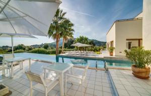 an outdoor patio with tables and chairs and a swimming pool at Son Sard Nou in Son Servera