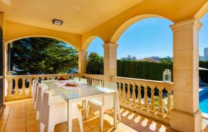 an outdoor patio with a white table and chairs at Ca Nostra in Cala Millor +40 photos