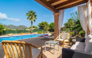 a patio with chairs and a swimming pool at Sa Plana Port Nou in Cala Millor