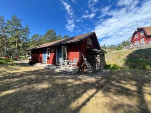 a red cottage with a red house on a hill at Cozy Studio on Utö Near Beach & Restaurant in Utö +26 photos