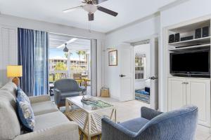 a living room with a couch and chairs and a tv at Hyatt Vacation Club at Beach House in Key West