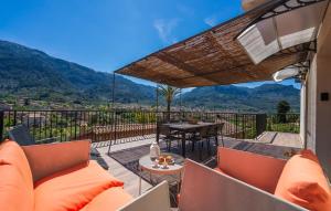 a balcony with orange chairs and a table with a view at Arbona Soller in Sóller
