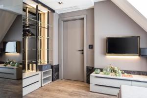 a living room with a sliding door and a tv at Hotel Michelangelo in Riccione +126 photos