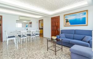 a living room with a blue couch and a table at Voramar On Pinewalk in Pollença +35 photos