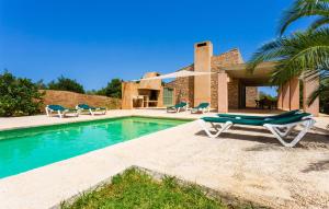 a villa with a swimming pool with a lounge chair at Clovetes in Son Servera