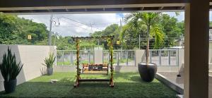 a room with a swing in a yard with green grass at Base Luz na Floresta in Manaus