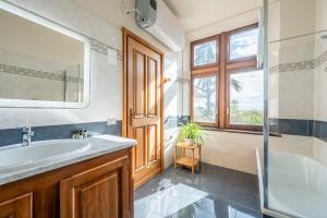 a bathroom with a sink and a tub and a window at Castello Quattro Torri in Arignano +70 photos