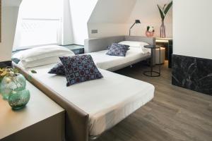 two beds sitting in a room with at Hotel Michelangelo in Riccione