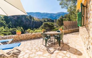 a patio with a table and chairs and a view at Antonio in Deia