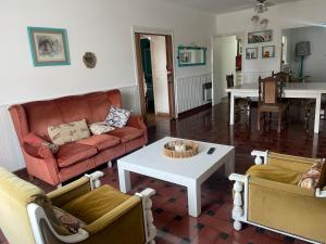 a living room with a couch and a table at Miramar2026 in Miramar