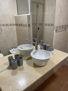 a bathroom with a sink and two bowls on a counter at Miramar2026 in Miramar