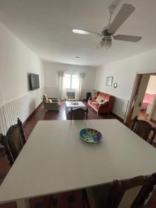 a living room with a table and a couch at Miramar2026 in Miramar